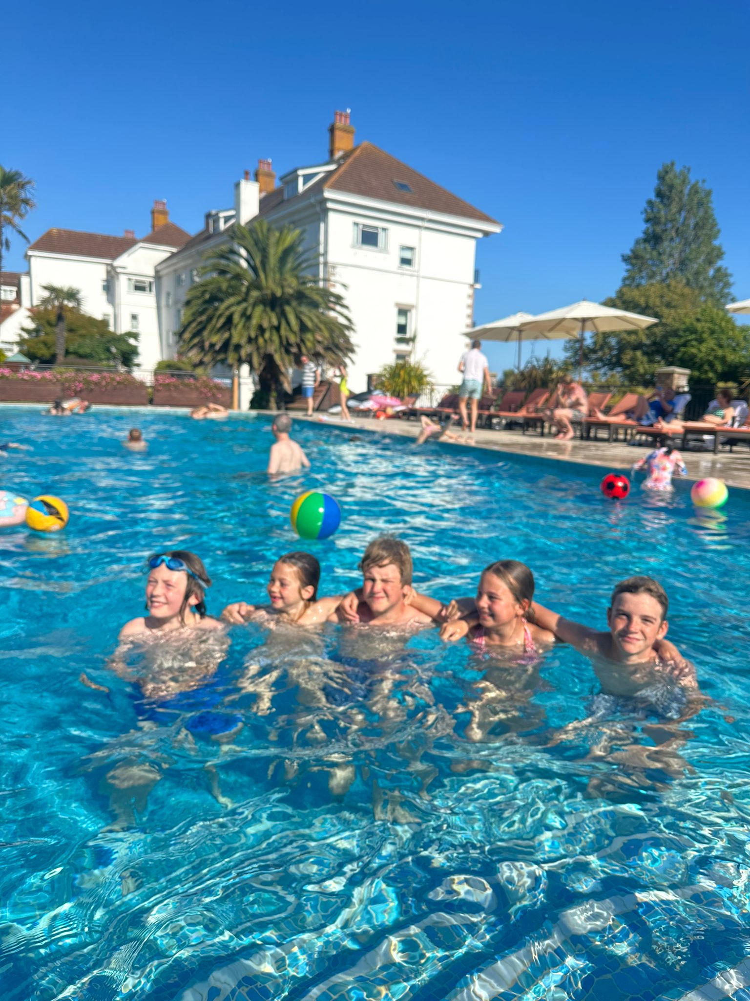 Group of kids having fun in Jersey's swimming pool